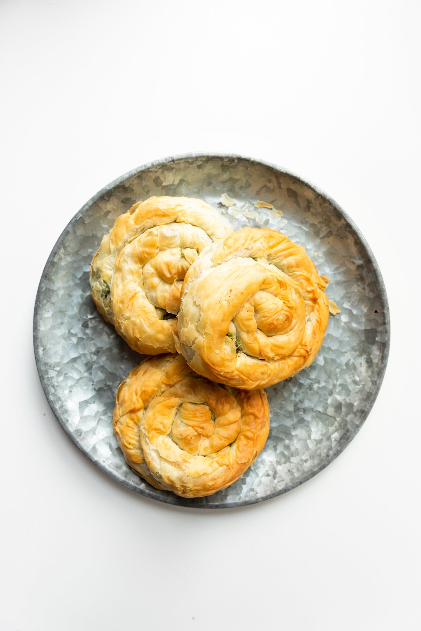 three-spanakopita-spirals-on-textured-plate